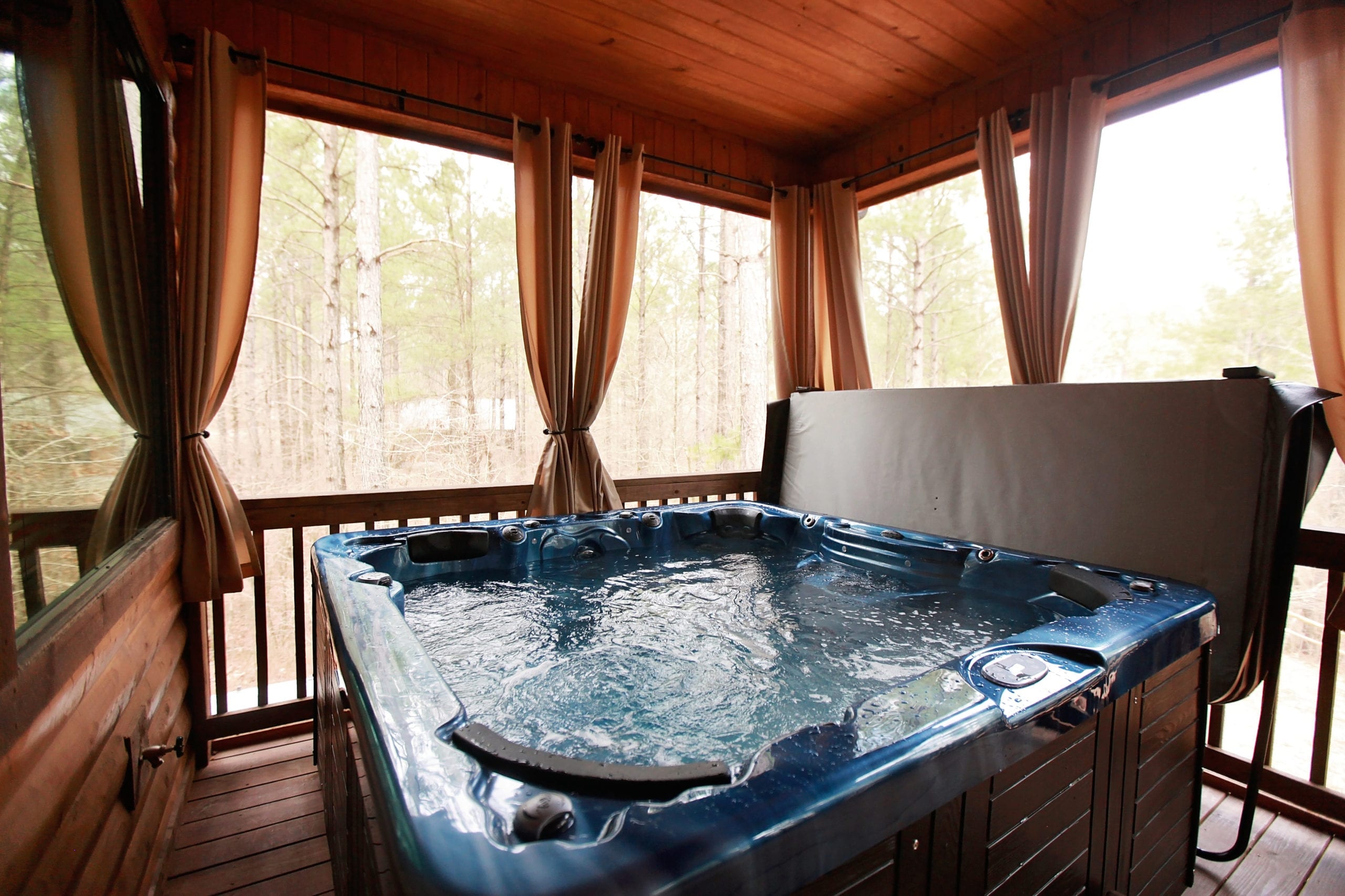 cabin enclosed porch with hot tub Blue Beaver Cabins