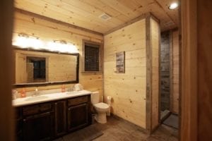 Stonewood Cabin bathroom with dual vanity sinks and luxury shower