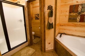 cabin bathroom with separate tub and shower