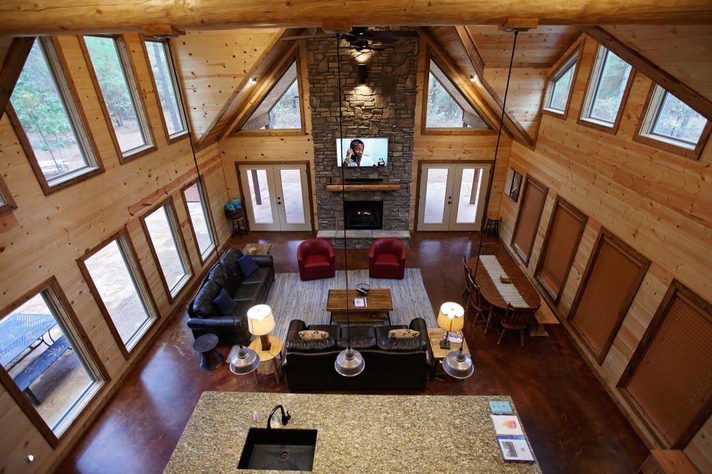 2nd floor view of cabin living room with fireplace