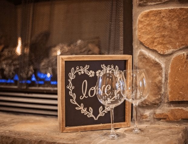 Close up of wine glasses on a fireplace mantle