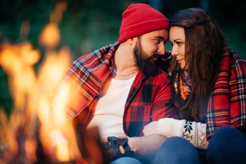 A couple huddled next to a fire, one of the best things to do in winter in Broken Bow, OK