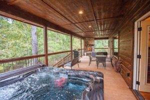 A romantic patio with a private hot tub in a luxury cabin in Broken Bow