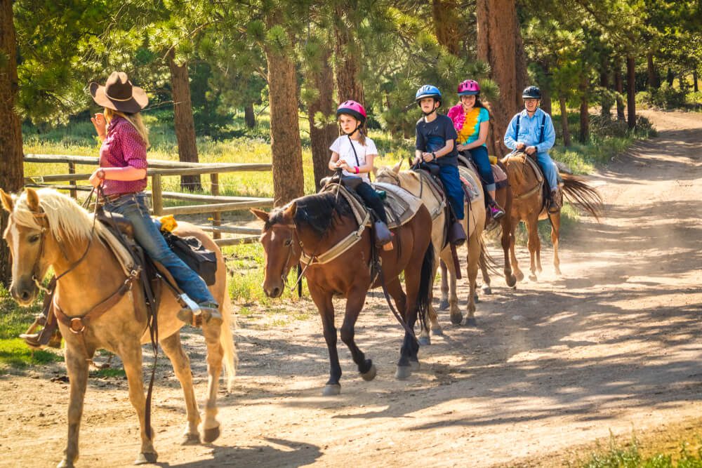 A family horseback riding, one of the top things to do in Hochatown, OK