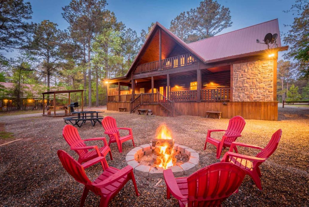 Silver Dollar Lodge exterior, fire pit and Adirondack chairs.