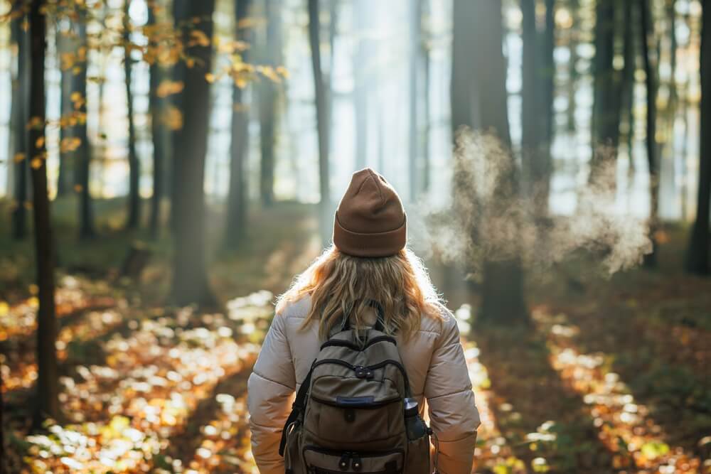 A woman exploring the forests of Broken Bow / Hochatown, Oklahoma, in winter